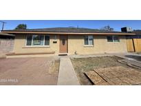 Charming single-story home featuring a neutral-toned exterior, well-maintained lawn, and inviting front entrance at 2724 W Highland Ave, Phoenix, AZ 85017