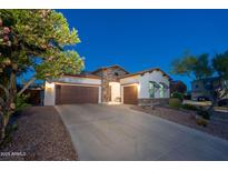 Charming single-Gathering home with a well-manicured yard, three-car garage, and stone accents at 31311 N 138Th Ave, Peoria, AZ 85383