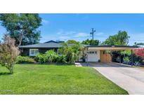Charming single story home with lush landscaping, covered carport and well-maintained lawn at 3351 N 6Th Ave, Phoenix, AZ 85013