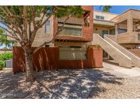 Well-maintained condo exterior with a private patio, a stairway, and desert landscaping at 3500 N Hayden Rd # 801, Scottsdale, AZ 85251
