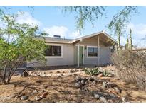 Charming single-story home featuring desert landscaping and a welcoming covered porch entrance at 3508 E Gelding Dr, Phoenix, AZ 85032