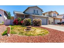 Charming two-story home featuring delightful curb appeal with bright pink and red bushes at 3829 W Camino Del Rio --, Glendale, AZ 85310