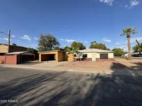 Charming single-story home featuring desert landscaping and a newly constructed garage with space for multiple vehicles at 4418 N 19Th Pl, Phoenix, AZ 85016