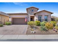 Beautiful desert home with stone accents, desert landscaping, brick driveway, and a two car garage at 6948 E Quill St, Mesa, AZ 85207