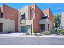 Modern two-story townhome featuring a two-car garage, landscaped front yard, and a stucco exterior finish at 7601 E Roosevelt St # 1012, Scottsdale, AZ 85257