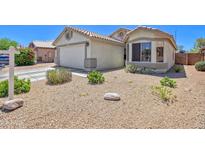 Charming home with a two-car garage, desert landscaping, and a cozy bay window at 10951 E Delta Ave, Mesa, AZ 85208