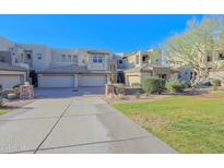 Inviting exterior view of home featuring a multi-car garage, desert landscaping, and architectural details at 14850 E Grandview Dr # 138, Fountain Hills, AZ 85268