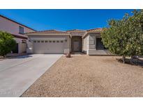 Charming single-story home featuring a low maintenance desert landscape and a two-car garage at 17844 W Caribbean Ln, Surprise, AZ 85388