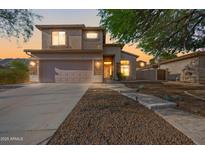 Charming two-story home boasts a stucco exterior, stone accents, and a well-manicured front yard at 1834 W Nighthawk Way, Phoenix, AZ 85045