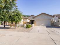 Charming single-story home featuring a two-car garage, low maintenance landscaping, and a inviting front entrance at 19403 E Arrowhead Trl, Queen Creek, AZ 85142
