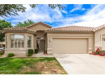 Charming single-story home with tile roof, desert landscaping, and a spacious two-car garage in a beautiful neighborhood at 23756 S Vacation Way, Sun Lakes, AZ 85248
