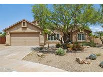 Charming single-story home featuring a well-maintained front yard, desert landscaping and a two-car garage at 28814 N 45Th St, Cave Creek, AZ 85331