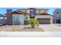 Charming two-story home with desert landscaping, stone accents, and a welcoming driveway at 3247 E Creosote Ln, Gilbert, AZ 85298
