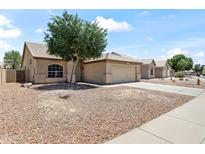 Charming single-story home with a two-car garage and mature landscaping in a residential neighborhood at 351 N Danyell Dr, Chandler, AZ 85225