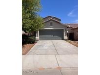 Single story home featuring a two car garage and a low maintenance yard at 41228 W Little Dr, Maricopa, AZ 85138