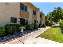Charming townhome featuring a well-kept lawn and a cozy front entrance, perfect for a relaxed lifestyle at 4630 N 68Th St # 264, Scottsdale, AZ 85251
