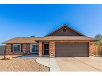 Charming single-story brick home featuring a two-car garage and well-maintained front yard at 4845 W Evans Dr, Glendale, AZ 85306