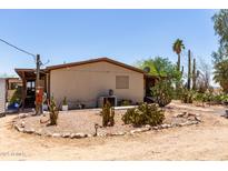 View of home exterior with desert landscaping including cacti and gravel at 49478 W Val Vista Rd, Maricopa, AZ 85139