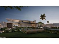 Striking modern home featuring sleek lines, a grand entrance, and lush landscaping against a twilight sky at 6525 E Bluebird Ln, Paradise Valley, AZ 85253