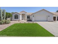 Charming single-story home with well-manicured front yard and two-car garage at 7144 E Lakeview Ave, Mesa, AZ 85209