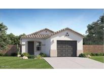 Charming single-story home featuring a tile roof, well-manicured lawn, and attached two car garage at 12039 E Primrose Ln, Florence, AZ 85132