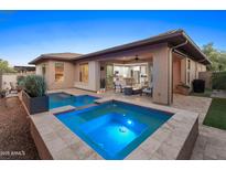 Inviting backyard features a modern pool and spa, perfect for outdoor relaxation and entertainment at 13186 W Via Dona Rd, Peoria, AZ 85383