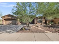 Charming single-story home with a three car garage and desert landscaping at 13945 E Gail Rd, Scottsdale, AZ 85259