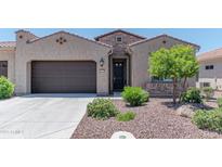 Charming home with a well-maintained landscaped front yard, a two-car garage, and a welcoming entrance at 16417 W Piccadilly Rd, Goodyear, AZ 85395