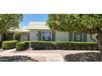 Charming single-story home featuring lush landscaping and secure window coverings at 17056 N 107Th Ave, Sun City, AZ 85373