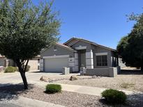 Charming single-story home with a two-car garage and well-maintained desert landscaping in front yard at 20931 E Desert Hills Blvd, Queen Creek, AZ 85142