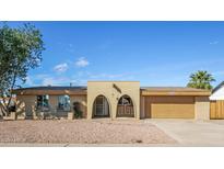 Charming single-level home featuring desert landscaping and a welcoming arched entryway, plus an attached two-car garage at 4062 W Eva St, Phoenix, AZ 85051