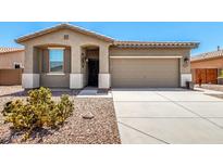 Charming single story home with a desert landscape and neutral color palette at 42519 W Centennial Ct, Maricopa, AZ 85138