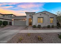 Charming single story home with a neutral colored exterior and desert landscaping at 4360 S Atom --, Mesa, AZ 85212