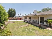 Expansive backyard features a covered patio, mature trees, lush lawn, and plenty of space for outdoor activities at 4515 N 35Th St, Phoenix, AZ 85018