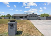 Charming single-story home featuring a large front yard, gray painted brick, and a two car garage at 4602 W Monte Cristo Ave, Glendale, AZ 85306