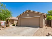 Charming single-story home with a two-car garage and a well-manicured front yard and walkway at 5401 W Jessica Ln, Laveen, AZ 85339