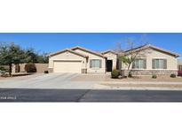 Charming single-story home with a two-car garage, desert landscaping, and a welcoming entrance at 5616 W Hidalgo Ave, Laveen, AZ 85339