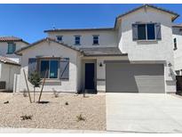 Charming two-story home boasts a modern exterior, desert landscaping, and a two-car garage at 7216 E Blissful Breeze Ln, San Tan Valley, AZ 85143