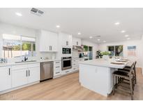 Bright kitchen boasts white cabinets, stainless steel appliances, and a spacious center island with bar seating at 7223 N 14Th St, Phoenix, AZ 85020