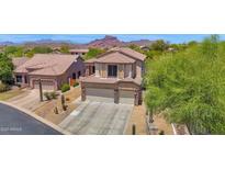 Charming two-story home showcasing desert landscaping and a three-car garage at 7260 E Tasman St, Mesa, AZ 85207