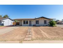 Charming single-story home with desert landscaping and covered carport at 8339 W Devonshire Ave, Phoenix, AZ 85037