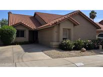 Charming single-level home with desert landscaping, a tile roof, and a two-car garage at 9285 E Sutton Dr, Scottsdale, AZ 85260