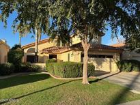 Charming single-Gathering home with a well-manicured lawn and mature landscaping at 11028 W Crimson Ln, Avondale, AZ 85392