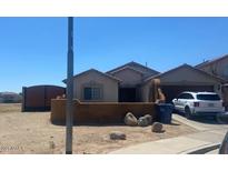 Charming single-Gathering home with desert landscaping, a two-car garage, and neutral color palette at 12501 W Rosewood Dr, El Mirage, AZ 85335