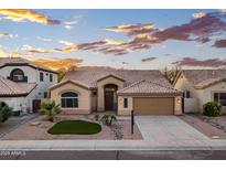Charming single-story home with a tile roof and low-maintenance desert landscaping against a beautiful sunset sky at 1398 W Windhaven Ave, Gilbert, AZ 85233
