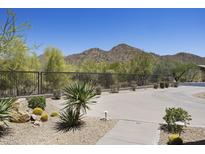 Desert landscaping frames the driveway with mountain views in the background at 14007 E Lupine Ave, Scottsdale, AZ 85259