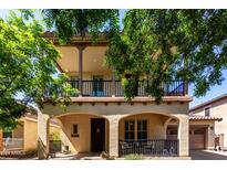 Inviting home featuring a covered front porch and a second-story balcony at 15456 W Corrine Dr, Surprise, AZ 85379