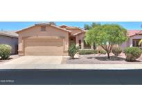 Single-story home featuring a two-car garage, neutral stucco, desert landscaping and a tile roof at 1880 E Birch St, Casa Grande, AZ 85122
