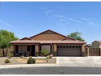 Charming single-story home showcasing a well-manicured lawn and a spacious two-car garage at 1898 N Hubbard Ln, Casa Grande, AZ 85122