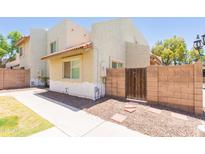 Charming townhome with stucco walls, a tiled roof, and private gated entry at 222 W Brown Rd # 72, Mesa, AZ 85201
